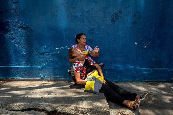 A woman was affected by tear gas fired near the police station. Credit Miguel Gutiérrez/EPA, via Shutterstock