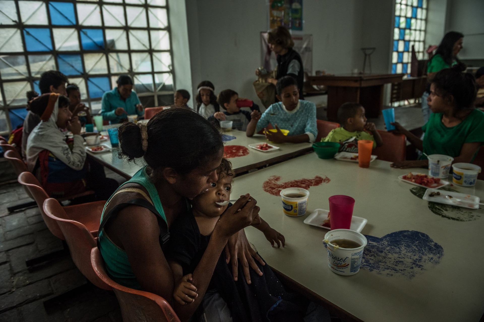 María Tocuyo, 28, feeding her 1-year-old daughter at a soup kitchen